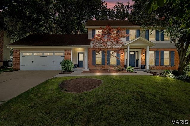 15495 Long Castle Forest Ct, Chesterfield, MO 63017 - view of front facade featuring brick siding, concrete driveway, a garage, and a lawn
