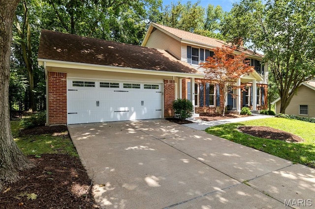 15495 Long Castle Forest Ct, Chesterfield, MO 63017 - view of front of house with brick siding, concrete driveway, and an attached garage