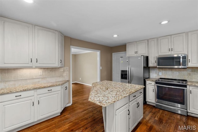 15495 Long Castle Forest Ct, Chesterfield, MO 63017 - kitchen featuring stainless steel appliances, backsplash, white cabinetry, recessed lighting, and a center island