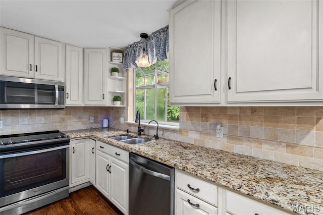 15495 Long Castle Forest Ct, Chesterfield, MO 63017 - kitchen with appliances with stainless steel finishes, white cabinetry, light stone counters, and tasteful backsplash