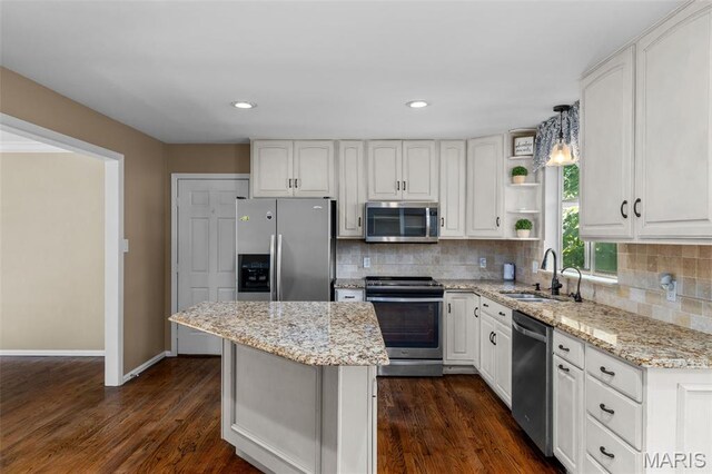 15495 Long Castle Forest Ct, Chesterfield, MO 63017 - kitchen with appliances with stainless steel finishes, white cabinets, light stone counters, backsplash, and recessed lighting