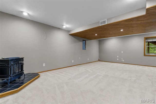 15495 Long Castle Forest Ct, Chesterfield, MO 63017 - basement featuring a wood stove, carpet, and recessed lighting