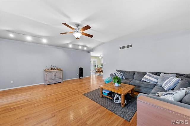 1745 Woodwind Dr, Imperial, MO 63052 - living room featuring track lighting, ceiling fan, vaulted ceiling, and light wood-style floors