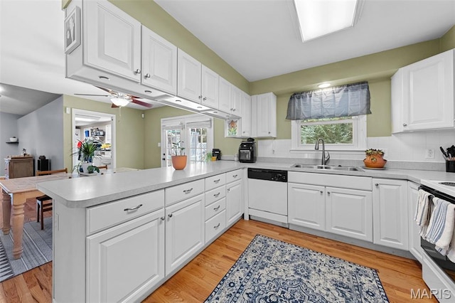 1745 Woodwind Dr, Imperial, MO 63052 - kitchen with white appliances, a peninsula, light countertops, and light wood finished floors