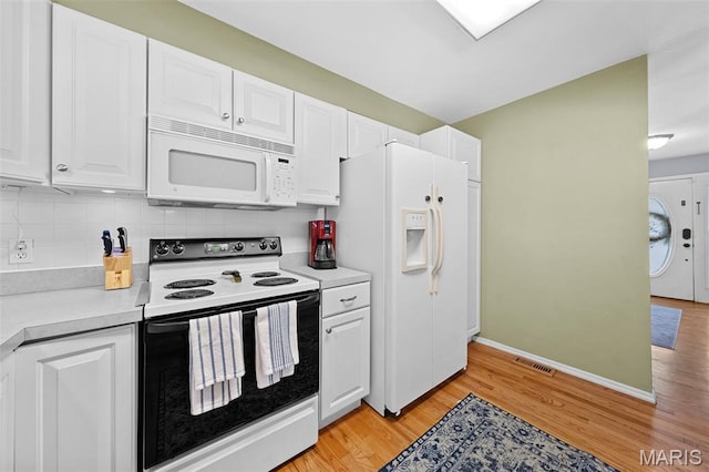 1745 Woodwind Dr, Imperial, MO 63052 - kitchen featuring white appliances, white cabinetry, light countertops, light wood-type flooring, and decorative backsplash