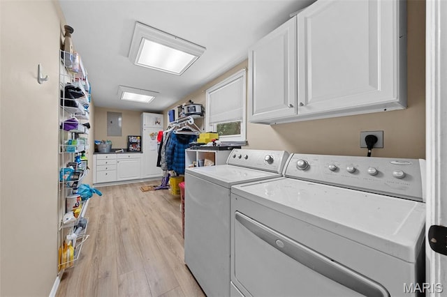 1745 Woodwind Dr, Imperial, MO 63052 - laundry room featuring cabinet space, washer and dryer, electric panel, and light wood finished floors