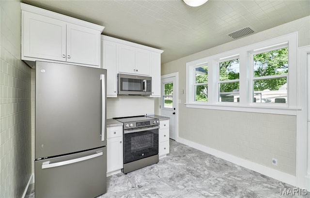 900 3rd St, Troy, MO 63379 - kitchen with stainless steel appliances and white cabinetry
