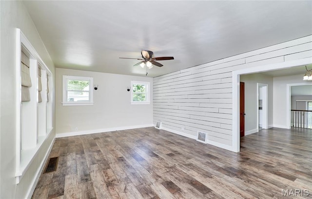 900 3rd St, Troy, MO 63379 - spare room with wooden walls, ceiling fan, and wood finished floors
