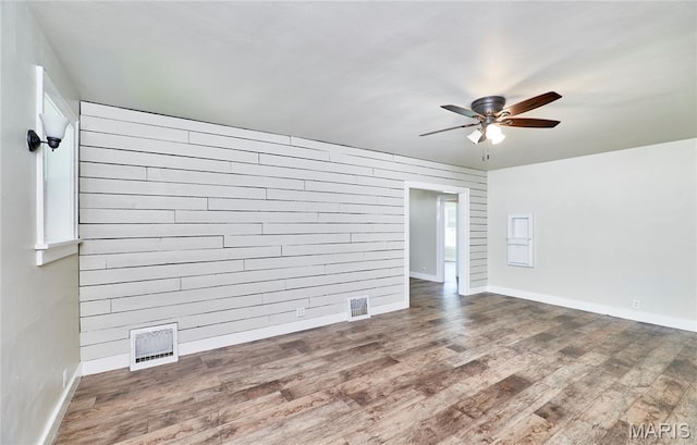 900 3rd St, Troy, MO 63379 - empty room featuring ceiling fan, wood finished floors, and wood walls