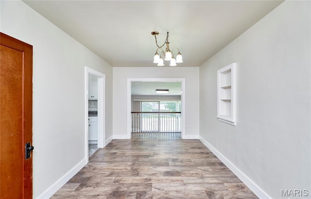 900 3rd St, Troy, MO 63379 - unfurnished dining area with wood finished floors and a chandelier