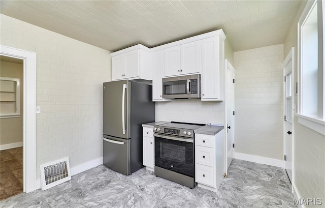 900 3rd St, Troy, MO 63379 - kitchen with stainless steel appliances, white cabinets, and tile walls