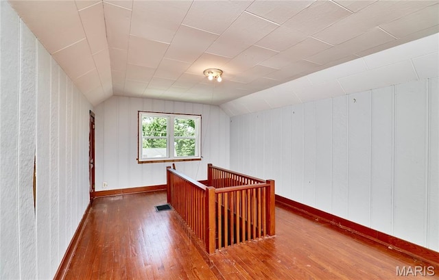 900 3rd St, Troy, MO 63379 - additional living space featuring hardwood / wood-style floors, vaulted ceiling, and wood walls