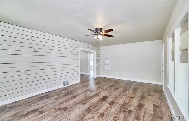 900 3rd St, Troy, MO 63379 - unfurnished room featuring ceiling fan, wood finished floors, and wood walls
