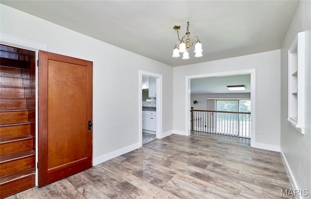 900 3rd St, Troy, MO 63379 - unfurnished room with wood finished floors and a chandelier