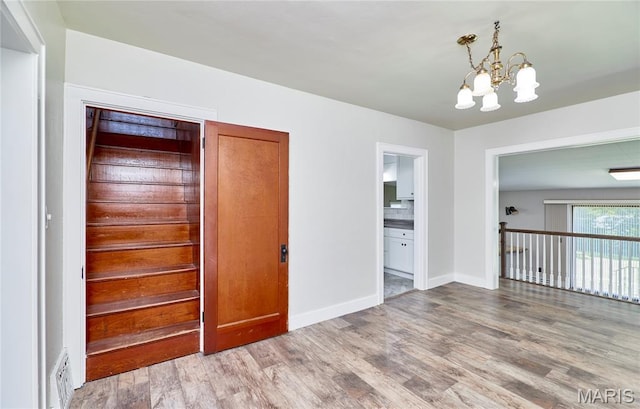 900 3rd St, Troy, MO 63379 - unfurnished room with a chandelier and light wood finished floors