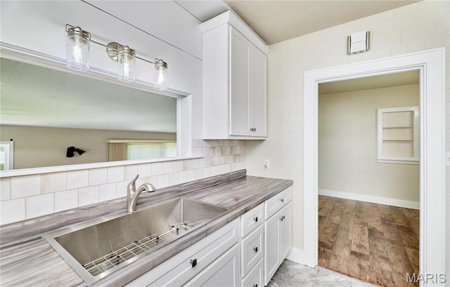 900 3rd St, Troy, MO 63379 - kitchen with white cabinetry, light wood-type flooring, and tasteful backsplash