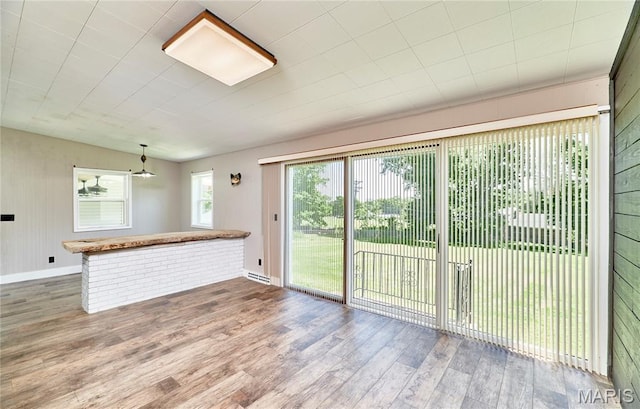 900 3rd St, Troy, MO 63379 - unfurnished living room featuring wood finished floors and baseboards