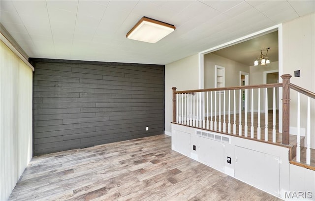 900 3rd St, Troy, MO 63379 - spare room featuring wood finished floors and a chandelier
