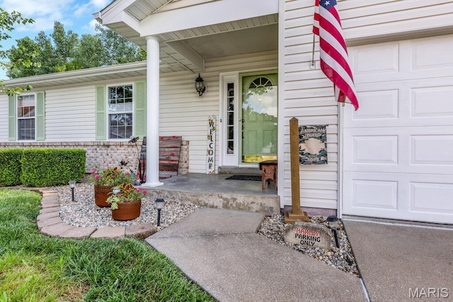 7 Mcclay Village Cir, Saint Peters, MO 63376 - property entrance with a porch, an attached garage, and brick siding