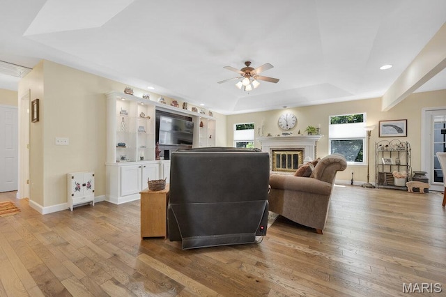 7 Mcclay Village Cir, Saint Peters, MO 63376 - living area featuring a raised ceiling, ceiling fan, light wood-style flooring, recessed lighting, and a fireplace