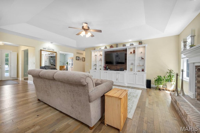 7 Mcclay Village Cir, Saint Peters, MO 63376 - living area featuring a tray ceiling, ceiling fan, hardwood / wood-style flooring, and healthy amount of natural light