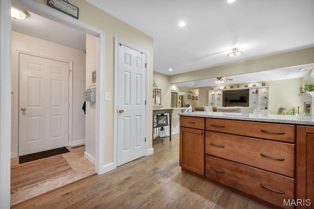 7 Mcclay Village Cir, Saint Peters, MO 63376 - kitchen featuring open floor plan, brown cabinetry, light wood finished floors, ceiling fan, and recessed lighting