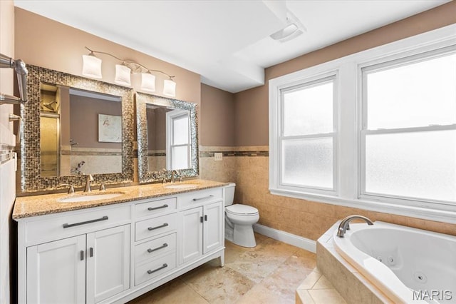 7248 Dorset Ave, University City, MO 63130 - full bath featuring plenty of natural light, a tub with jets, double vanity, tile walls, and a shower with door