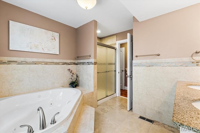 7248 Dorset Ave, University City, MO 63130 - bathroom featuring tile walls, a shower stall, a whirlpool tub, tile patterned floors, and a wainscoted wall