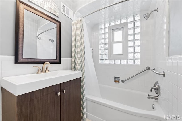 7248 Dorset Ave, University City, MO 63130 - full bathroom featuring shower / bath combo, tile walls, wainscoting, and vanity