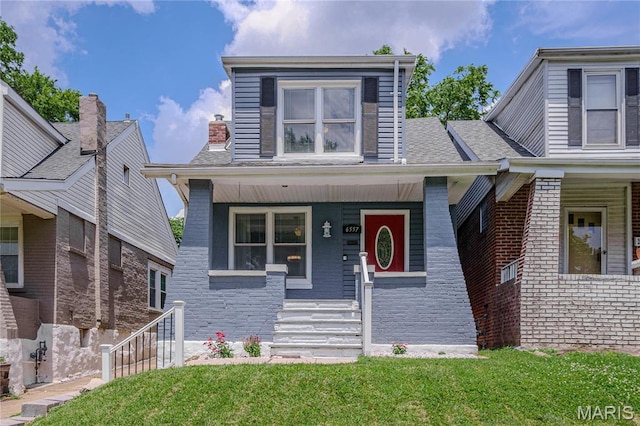 6557 Marmaduke Ave, Saint Louis, MO 63139 - view of front of house with covered porch and a front yard