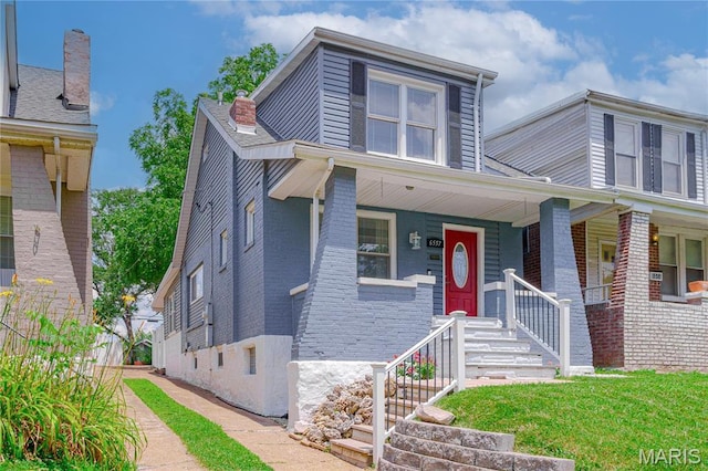 6557 Marmaduke Ave, Saint Louis, MO 63139 - view of front of property featuring brick siding and covered porch