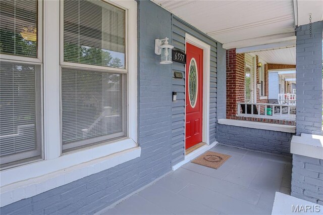 6557 Marmaduke Ave, Saint Louis, MO 63139 - property entrance with a porch and brick siding