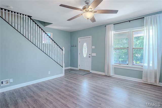 6557 Marmaduke Ave, Saint Louis, MO 63139 - entryway with stairs, a ceiling fan, and wood finished floors
