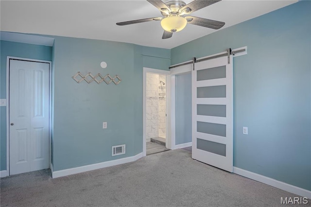 6557 Marmaduke Ave, Saint Louis, MO 63139 - unfurnished bedroom with a barn door, carpet flooring, a closet, and a ceiling fan