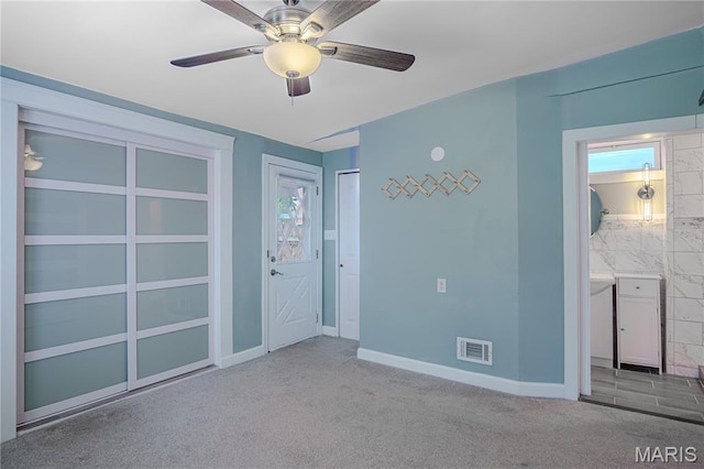 6557 Marmaduke Ave, Saint Louis, MO 63139 - unfurnished bedroom featuring carpet floors, ensuite bathroom, and a ceiling fan