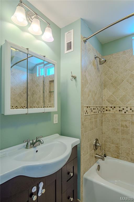 6557 Marmaduke Ave, Saint Louis, MO 63139 - bathroom with  shower combination and vanity