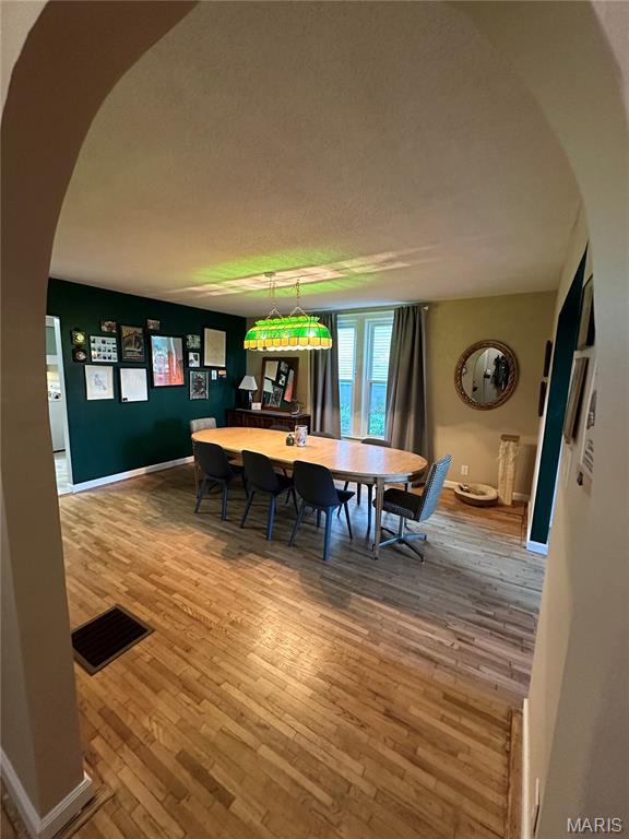 325 N Prairie St, Greenville, IL 62246 - dining room with wood finished floors and arched walkways