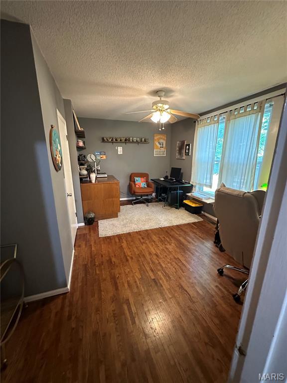 325 N Prairie St, Greenville, IL 62246 - office with dark wood-style floors, a textured ceiling, and a ceiling fan