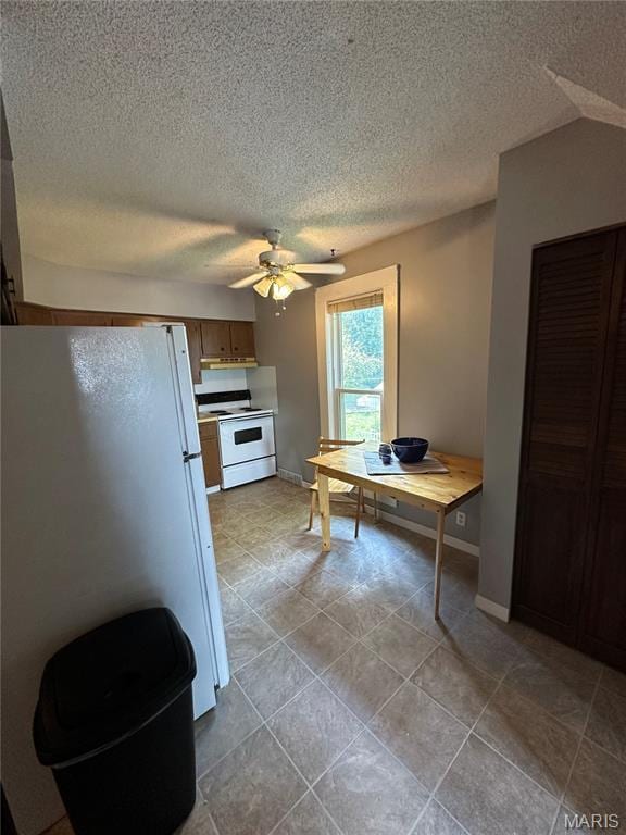 325 N Prairie St, Greenville, IL 62246 - kitchen with white appliances, a ceiling fan, a textured ceiling, and light tile patterned floors