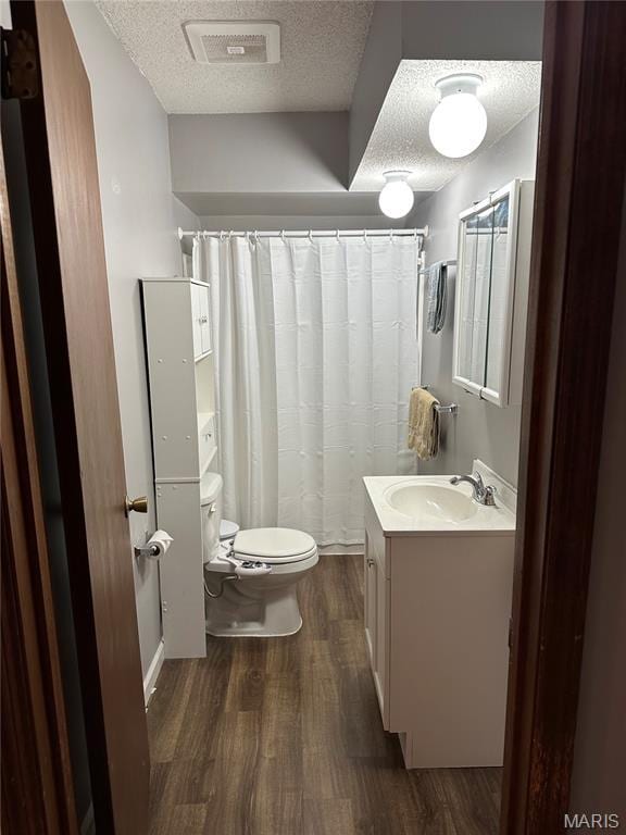 325 N Prairie St, Greenville, IL 62246 - full bathroom featuring wood finished floors, a textured ceiling, vanity, and a shower with curtain