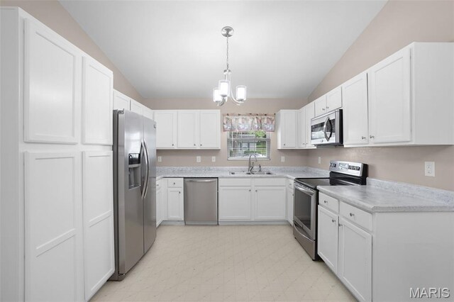1222 W 8th St, Washington, MO 63090 - kitchen featuring stainless steel appliances, vaulted ceiling, a chandelier, light countertops, and white cabinets