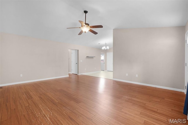 1222 W 8th St, Washington, MO 63090 - unfurnished living room with ceiling fan, vaulted ceiling, a chandelier, and wood finished floors