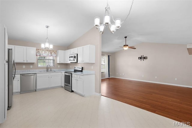 1222 W 8th St, Washington, MO 63090 - kitchen with appliances with stainless steel finishes, a chandelier, open floor plan, lofted ceiling, and a ceiling fan