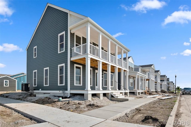 2921 Memphis St, Saint Charles, MO 63301 - view of property exterior featuring a balcony, a porch, and a residential view