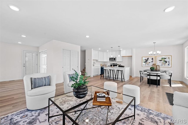 2921 Memphis St, Saint Charles, MO 63301 - living area with light wood-type flooring, a chandelier, and recessed lighting