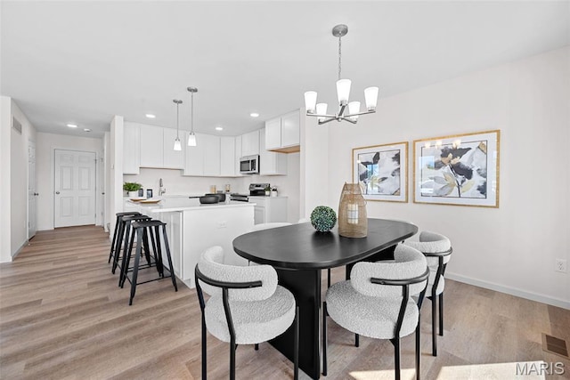 2921 Memphis St, Saint Charles, MO 63301 - dining space featuring a chandelier, recessed lighting, and light wood finished floors