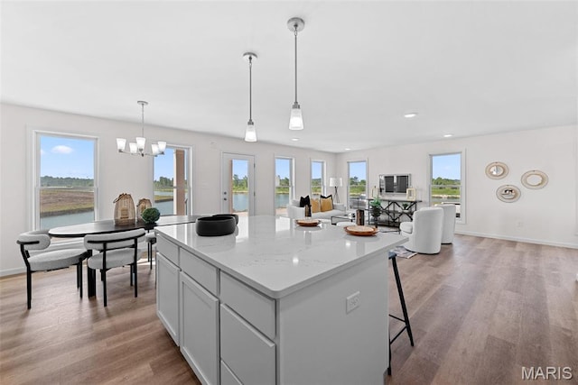2921 Memphis St, Saint Charles, MO 63301 - kitchen featuring a kitchen island, light wood-style floors, a chandelier, recessed lighting, and decorative light fixtures