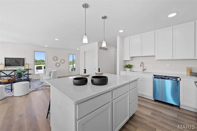 2921 Memphis St, Saint Charles, MO 63301 - kitchen with dishwasher, wood finished floors, white cabinetry, recessed lighting, and open floor plan