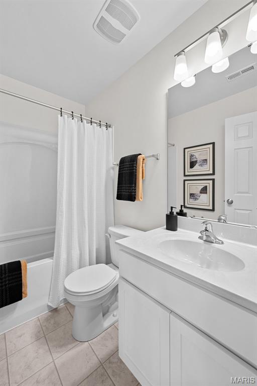 2921 Memphis St, Saint Charles, MO 63301 - full bathroom featuring vanity, tile patterned flooring, and shower / bathtub combination with curtain