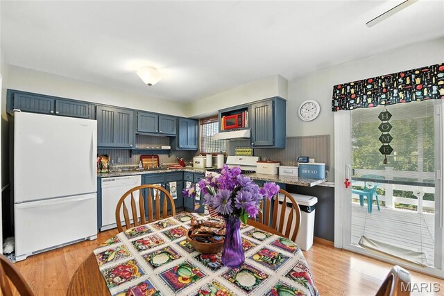 1918 Lone Pine Dr, Arnold, MO 63010 - kitchen with white appliances, under cabinet range hood, light wood-style flooring, and light countertops